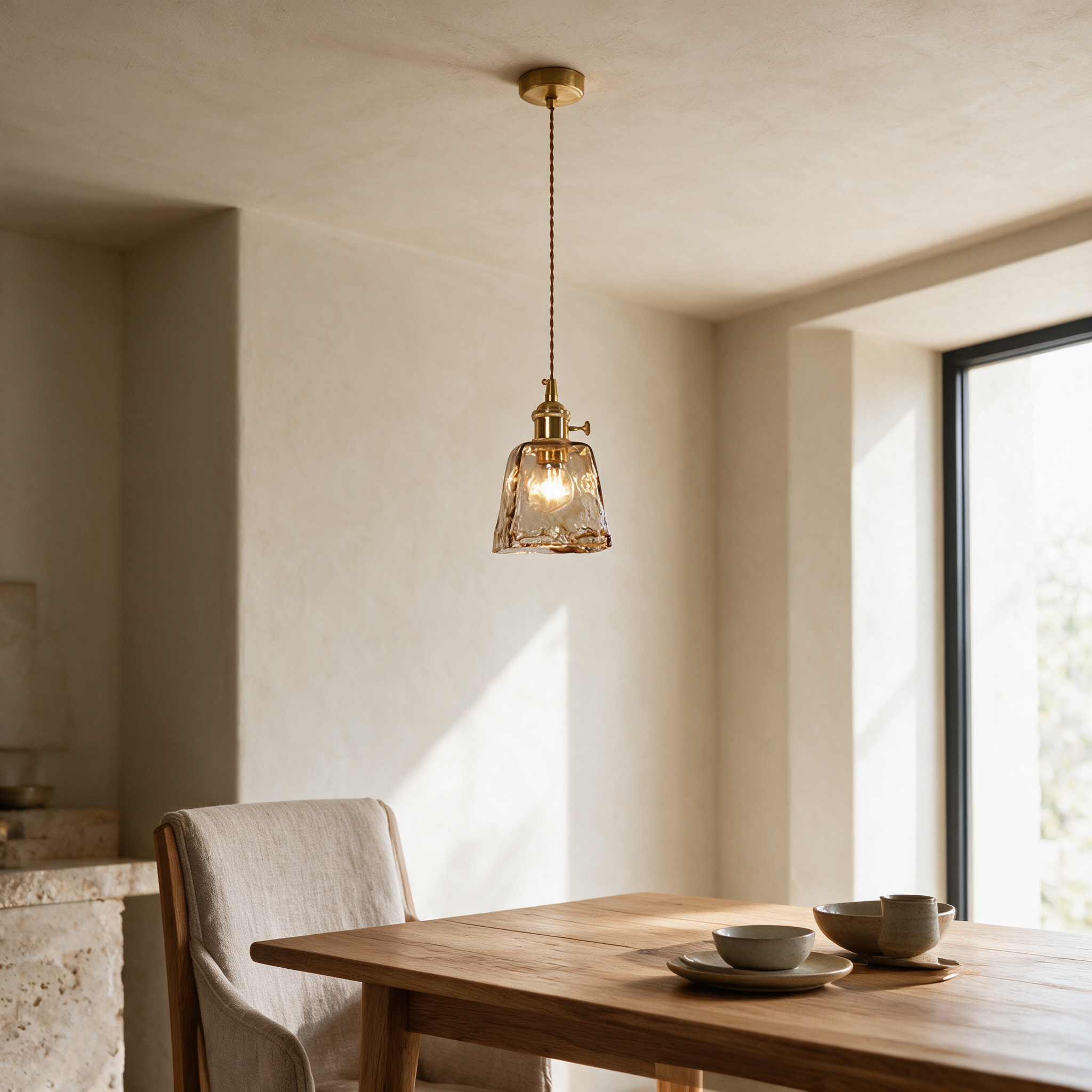 Vintage amber glass pendant light hanging above a wooden dining table