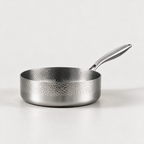 Hammered stainless steel frying pan on a stone worktop