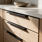 Matte black recessed aluminium handles fitted to oak kitchen drawers