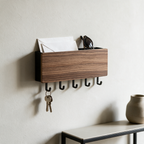 Walnut wall-mounted key rack with five hooks holding keys and letters